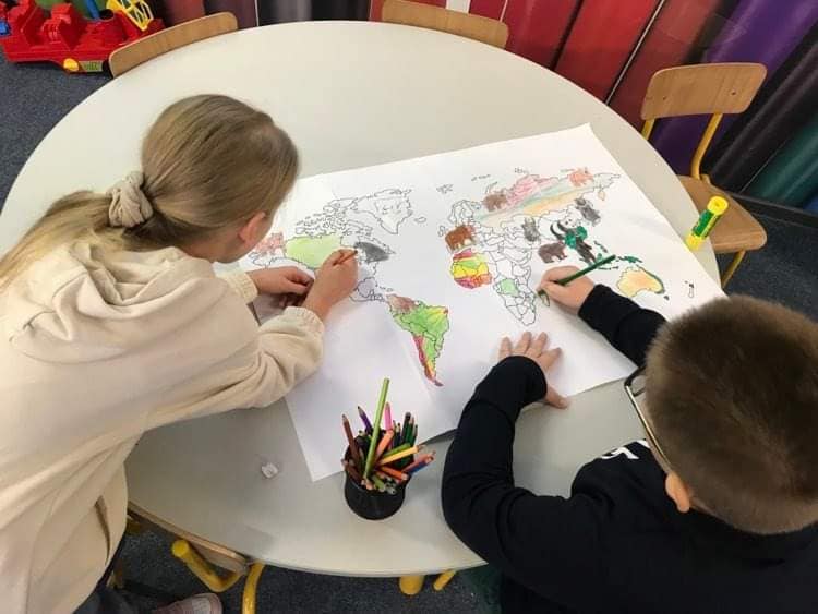 uczniowie kolorują mapę świata